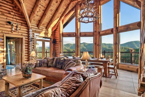 Great room with vaulted ceiling, floor-to-ceiling windows, and mountain views